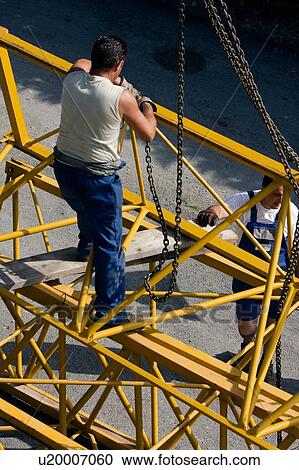 aerial view of workman attaching hooks to part of crane boom to be lifted View Large Photo Image Stock Image - aerial view of workman attaching hooks to part of crane boom to be lifted . Fotosearch