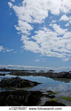 Arolainish Bay, Isle of Mull, Scotland with tidal pools at beach reflecting blue sky and white cloud formations, rocks silhouetted View Large Photo Image Stock Photo - Arolainish Bay, Isle of Mull, Scotland with tidal pools at beach reflecting blue sky and white cloud formations, rocks silhouetted. Fotosearch