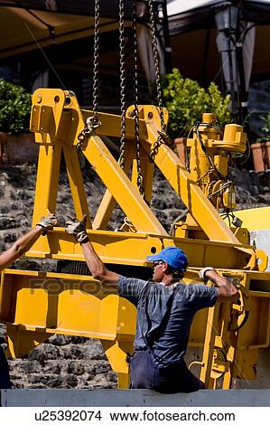 Picture - assembly of rotation platform of crane, workmen . Fotosearch