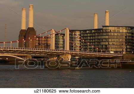 Stock Photography - Battersea power stationin evening light with railway bridge across River Thames in foreground. Fotosearch