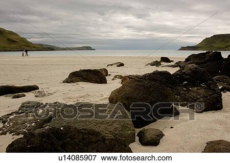 Stock Photo - beach view at Calgary bay on overcast day, Isle of Mull, Scotland, with people walking in distance. Fotosearch