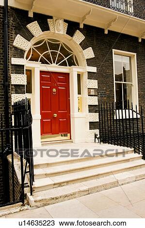 Stock Image - Bedford Square, Bloomsbury, London, detail of red door. Fotosearch