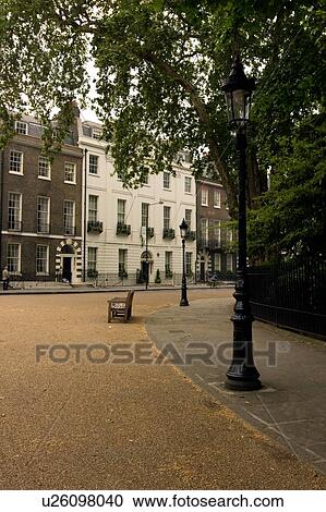 Stock Image - Bedford Square, Bloomsbury, London, view of curving path and houses. Fotosearch