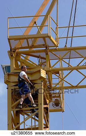 cabin and boom being atached to crane tower by workmen, close up View Large Photo Image Stock Photography - cabin and boom being atached to crane tower by workmen, close up. Fotosearch