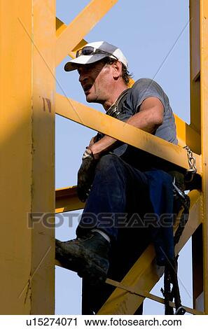 close up of workman sitting in crane tower, waiting and watching View Large Photo Image Stock Image - close up of workman sitting in crane tower, waiting and watching. Fotosearch