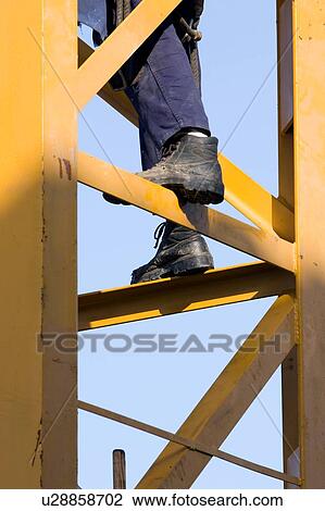 closeup of workman's feet balanced on crane tower View Large Photo Image Stock Image - closeup of workman's feet balanced on crane tower . Fotosearch