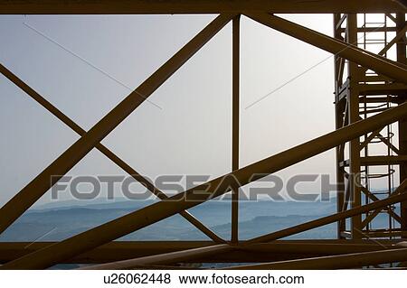 crane boom lying on ground with early morning mist of Italian landscape in background View Large Photo Image Stock Photo - crane boom lying on ground with early morning mist of Italian landscape in background . Fotosearch