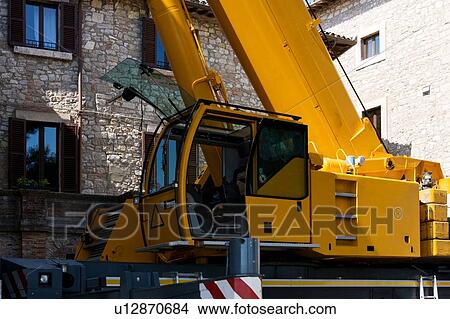 Crane cabin and base of tower, in Italian piazza with stone buildings in background View Large Photo Image Picture - Crane cabin and base of tower, in Italian piazza with stone buildings in background . Fotosearch