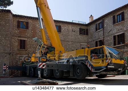 Crane cabin and base of tower in Italian piazza with stone buildings in background View Large Photo Image Stock Photo - Crane cabin and base of tower in Italian piazza with stone buildings in background . Fotosearch