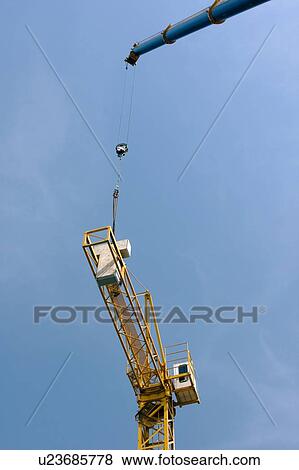 crane lowering cement blocks onto boom View Large Photo Image Stock Photo - crane lowering cement blocks onto boom. Fotosearch