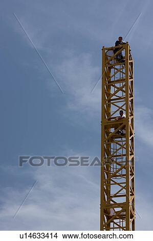 crane tower in assembly with two workmen waiting for next piece View Large Photo Image Picture - crane tower in assembly with two workmen waiting for next piece. Fotosearch