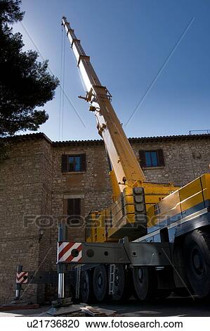 Crane tower pointing skyward, with Italian stone building in piazza View Large Photo Image Stock Image - Crane tower pointing skyward, with Italian stone building in piazza. Fotosearch