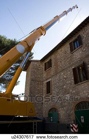Crane tower pointing skyward, with Italian stone building in piazza View Large Photo Image Stock Photo - Crane tower pointing skyward, with Italian stone building in piazza. Fotosearch