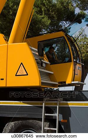 Stock Photography - detail of base, cabin with operator and lower part of tower of assembly crane. Fotosearch