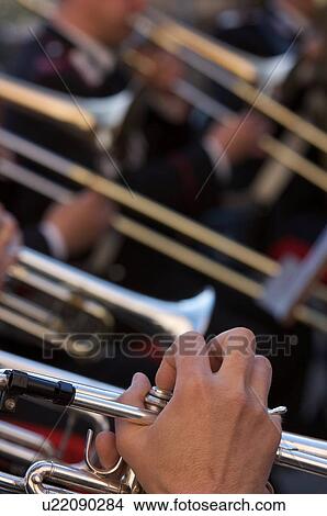 Picture - Detail of brass band instruments, with trumpets and trombones. Fotosearch