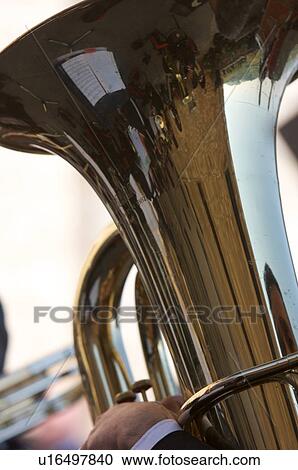 Stock Image - Detail of brass band instruments, with reflection of Italian church in euphonium. Fotosearch