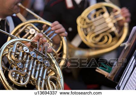 Detail of brass band instruments, with three French horns View Large Photo Image Stock Photo - Detail of brass band instruments, with three French horns. Fotosearch