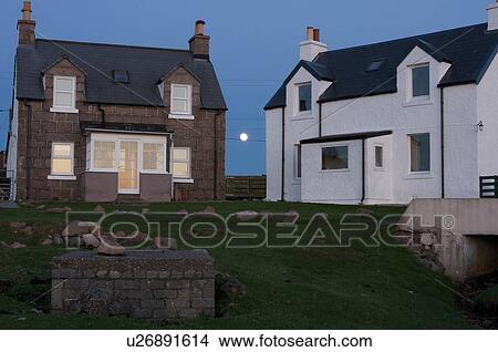 Full moon rising between houses in Kintra harbour View Large Photo Image Picture - Full moon rising between houses in Kintra harbour. Fotosearch