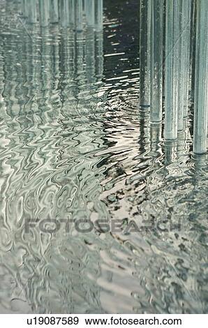 Stock Photo - glass tubes in ornamental garden pond display, with reflection . Fotosearch