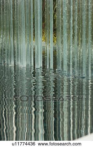 Stock Photograph - glass tubes in ornamental garden pond display, with reflection . Fotosearch