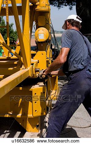 Man hammering assembly pinion of crane boom to rotating platform View Large Photo Image Stock Photograph - Man hammering assembly pinion of crane boom to rotating platform. Fotosearch