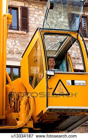 man operating crane from cabin from front View Large Photo Image Stock Photo - man operating crane from cabin from front . Fotosearch
