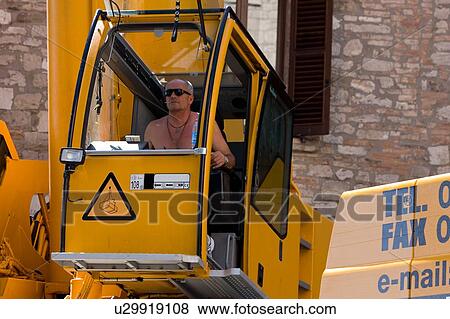 Stock Photo - man operating crane in cabin . Fotosearch