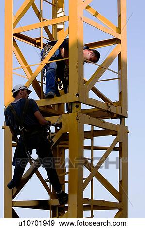 men assembling crane tower segments, new piece being positioned View Large Photo Image Stock Photo - men assembling crane tower segments, new piece being positioned. Fotosearch