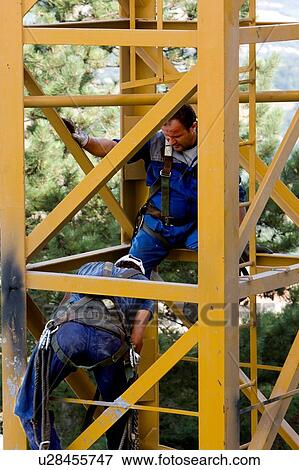 men assembling crane tower segments View Large Photo Image Stock Photo - men assembling crane tower segments . Fotosearch
