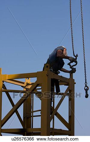 men assembling crane tower segments, with chains and connectors View Large Photo Image Stock Photograph - men assembling crane tower segments, with chains and connectors. Fotosearch