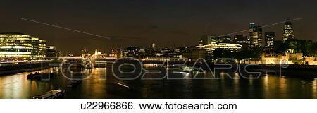 Panoramic view of London skyline at night, as seen from Tower bridge showing both banks of Thames river and HMS Belfast View Large Photo Image Stock Photograph - Panoramic view of London skyline at night, as seen from Tower bridge showing both banks of Thames river and HMS Belfast. Fotosearch