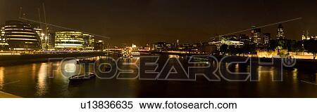 Panoramic view of London skyline at night, as seen from Tower bridge showing both banks of Thames river and HMS Belfast View Large Photo Image Stock Photography - Panoramic view of London skyline at night, as seen from Tower bridge showing both banks of Thames river and HMS Belfast. Fotosearch