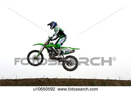 Single motocross rider flying through air, side view View Large Photo Image Stock Image - Single motocross rider flying through air, side view. Fotosearch