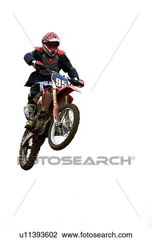 Stock Image - Single motocross rider flying through air, front view. Fotosearch