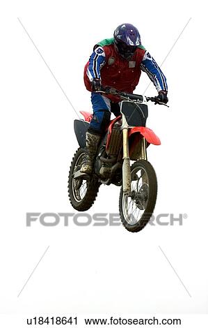 Single motocross rider flying through air, front view View Large Photo Image Stock Image - Single motocross rider flying through air, front view. Fotosearch