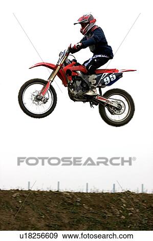 Single motocross rider flying through air, side view View Large Photo Image Stock Photo - Single motocross rider flying through air, side view. Fotosearch