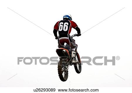 Single motocross rider flying through air, back view View Large Photo Image Stock Photo - Single motocross rider flying through air, back view. Fotosearch