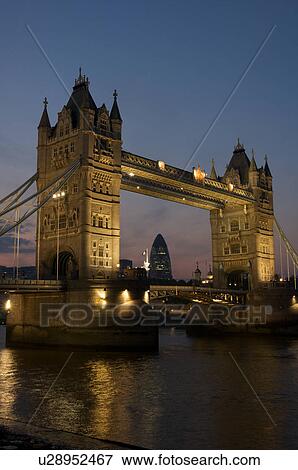 Stock Photo - Tower Bridge at night as seen from south bank of Thames. Fotosearch