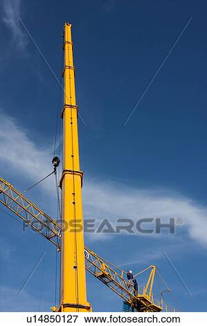 view of crane lifting crane boom into position for assembly View Large Photo Image Stock Photo - view of crane lifting crane boom into position for assembly . Fotosearch