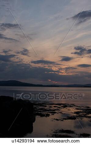 View of Loch Na Keal at sunset, Isle of Mull, Scotland, with tidal pools reflecting sky View Large Photo Image Picture - View of Loch Na Keal at sunset, Isle of Mull, Scotland, with tidal pools reflecting sky. Fotosearch