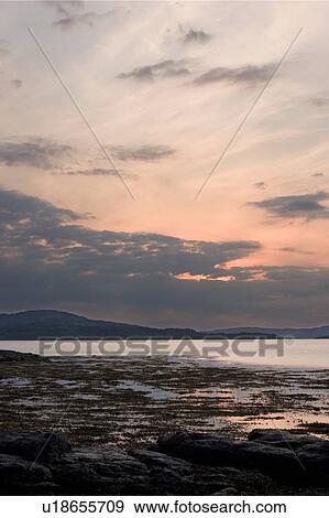 View of Loch Na Keal at sunset, Isle of Mull, Scotland, with tidal pools reflecting sky View Large Photo Image Stock Photo - View of Loch Na Keal at sunset, Isle of Mull, Scotland, with tidal pools reflecting sky. Fotosearch