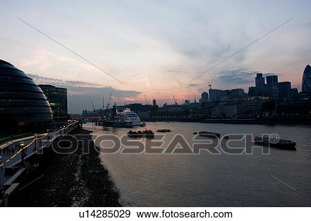 View of London skyline from Tower Bridge at sunset, showing both sides of river bank architecture and HMS Belfast View Large Photo Image Stock Photo - View of London skyline from Tower Bridge at sunset, showing both sides of river bank architecture and HMS Belfast. Fotosearch