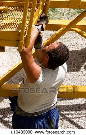 workman checking attachment point on crane boom on ground, closeup View Large Photo Image Stock Image - workman checking attachment point on crane boom on ground, closeup. Fotosearch