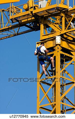 workman climbing crane tower during crane assembly View Large Photo Image Stock Photography - workman climbing crane tower during crane assembly. Fotosearch
