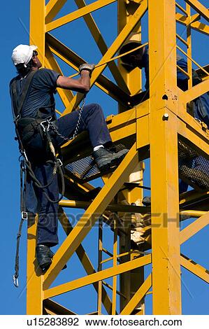 workman climbing on crane tower being assembled View Large Photo Image Stock Image - workman climbing on crane tower being assembled. Fotosearch