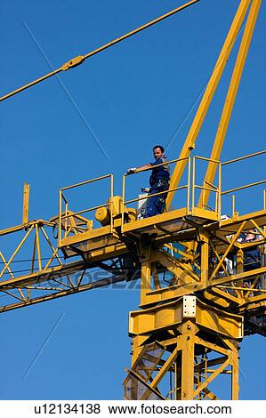workman on platform of crane boom during assembly View Large Photo Image Stock Photo - workman on platform of crane boom during assembly . Fotosearch