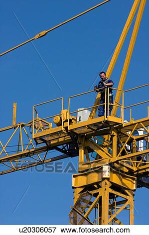 workman on platform of crane boom during assembly View Large Photo Image Stock Photo - workman on platform of crane boom during assembly . Fotosearch