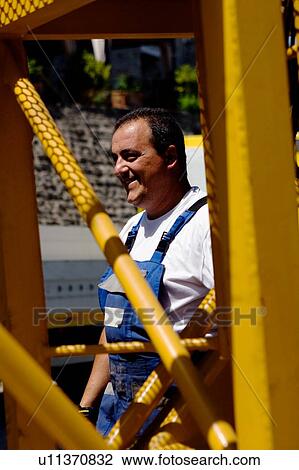 workman standing beside crane boom - closeup View Large Photo Image Stock Image - workman standing beside crane boom - closeup . Fotosearch