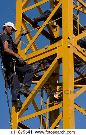workmen attaching new piece of crane tower swung in View Large Photo Image Stock Image - workmen attaching new piece of crane tower swung in . Fotosearch