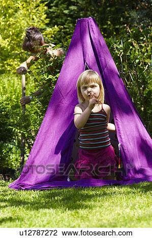Girl in a teepee, shot from outside View Large Photo Image Stock Image - Girl in a teepee, shot from outside. Fotosearch